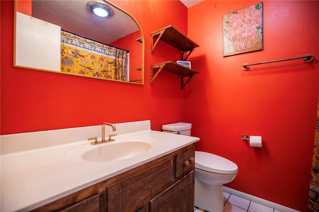 bathroom with vanity, toilet, tile patterned flooring, and a textured ceiling