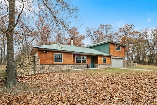 15258 Shipe Rd, Gravette, AR 72736 - view of front facade featuring stone siding, an attached garage, and metal roof