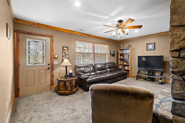 carpeted living room featuring ceiling fan and crown molding