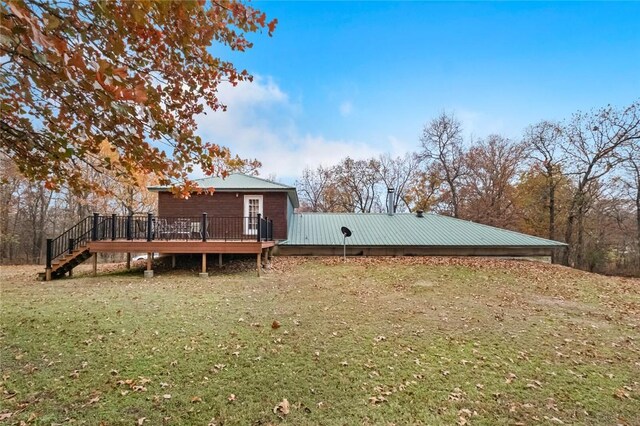 15258 Shipe Rd, Gravette, AR 72736 - rear view of property with a deck, a lawn, stairway, and metal roof