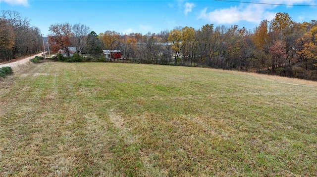 15258 Shipe Rd, Gravette, AR 72736 - view of green lawn with a forest view