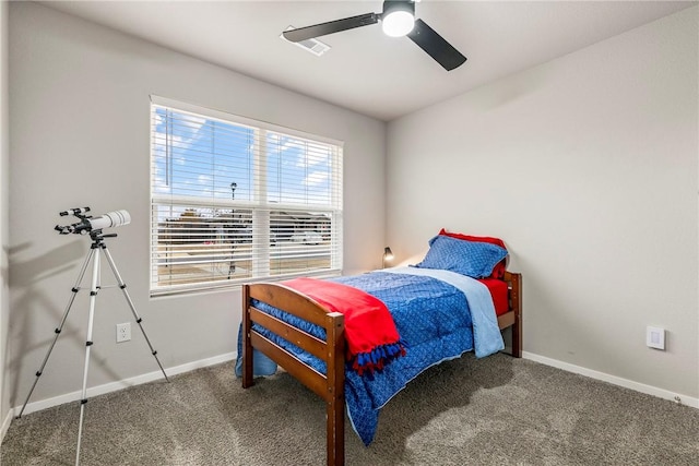 bedroom with ceiling fan and dark carpet