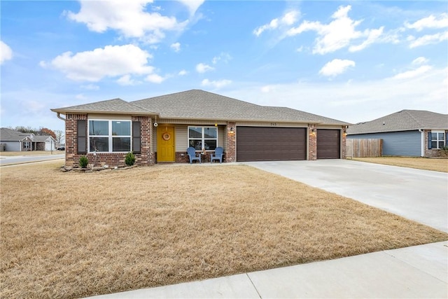 prairie-style home featuring a garage and a front lawn