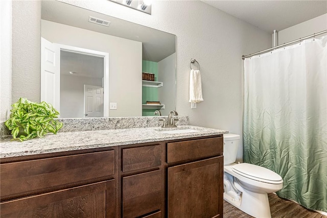 bathroom with vanity, hardwood / wood-style floors, and toilet