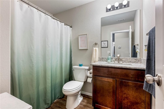 bathroom with wood-type flooring, toilet, and vanity