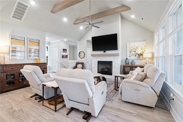 living room featuring beamed ceiling, light hardwood / wood-style floors, high vaulted ceiling, and a fireplace