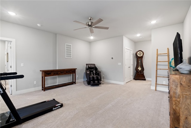 workout room with light carpet and ceiling fan