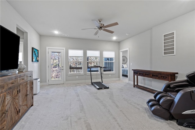 workout area featuring light carpet and ceiling fan