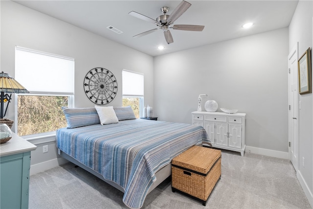 bedroom with ceiling fan and light colored carpet