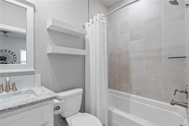 full bathroom featuring shower / bath combo with shower curtain, vanity, and toilet