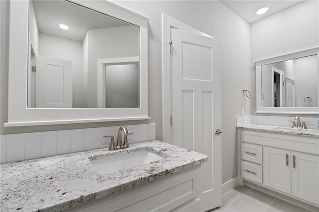 bathroom with tile patterned floors and vanity