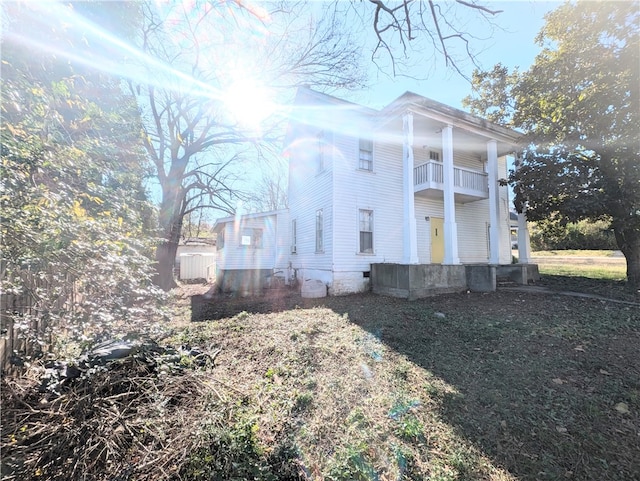 view of side of home featuring a balcony