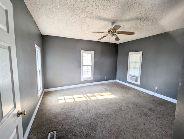 unfurnished room with a textured ceiling, carpet floors, and ceiling fan