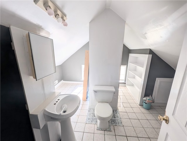 bathroom featuring tile patterned flooring, toilet, and lofted ceiling