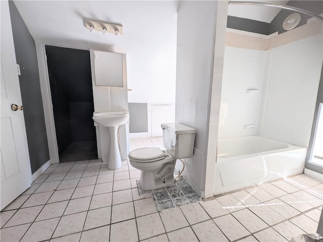 bathroom with shower / tub combination, tile patterned flooring, and toilet