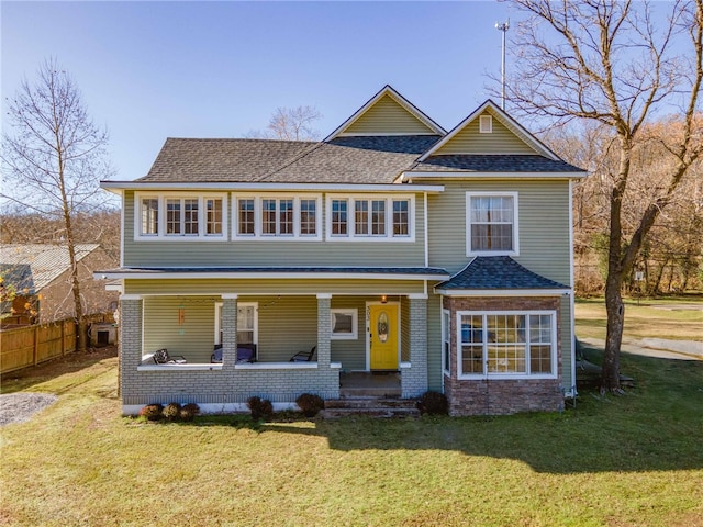 view of front of property featuring a porch and a front lawn