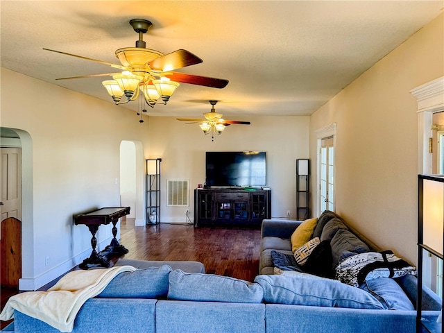 living room with a textured ceiling and dark hardwood / wood-style floors