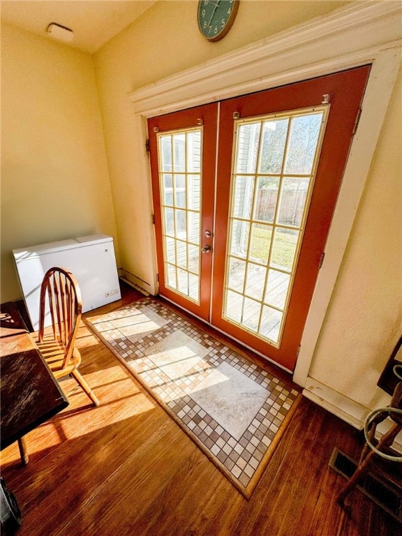 entryway with french doors and wood-type flooring