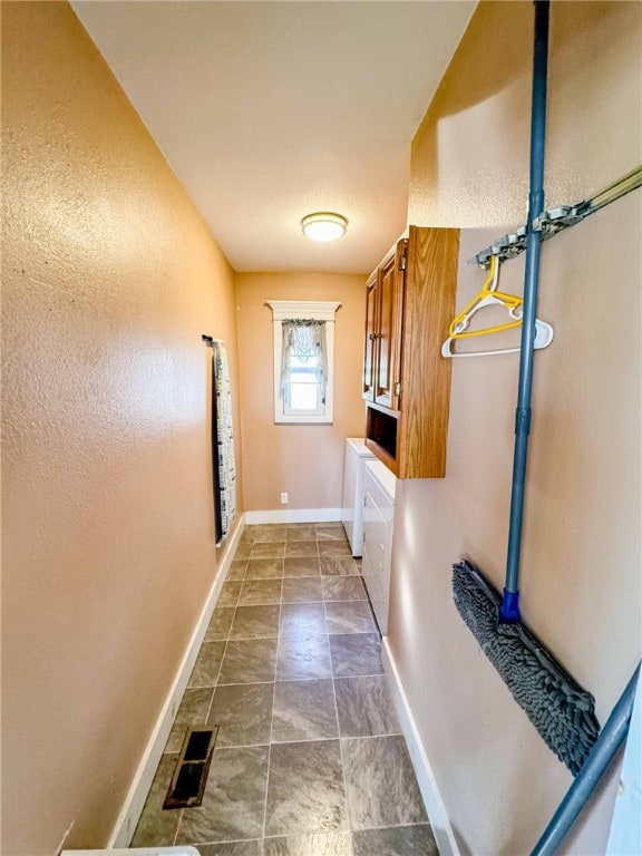 laundry area with washer and dryer and cabinets