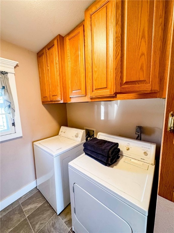 washroom featuring washer and dryer and cabinets