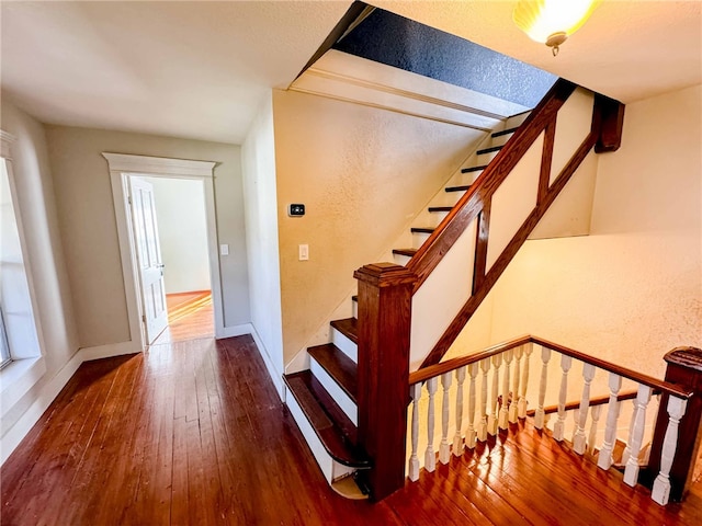 staircase with hardwood / wood-style flooring