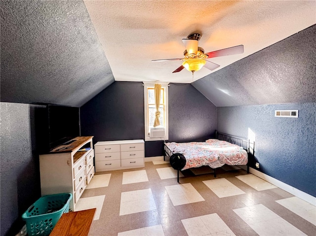 unfurnished bedroom featuring ceiling fan, lofted ceiling, and a textured ceiling