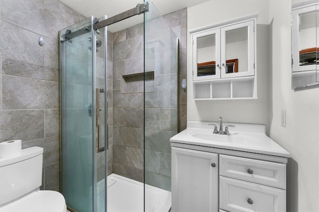 bathroom featuring vanity, toilet, and walk in shower