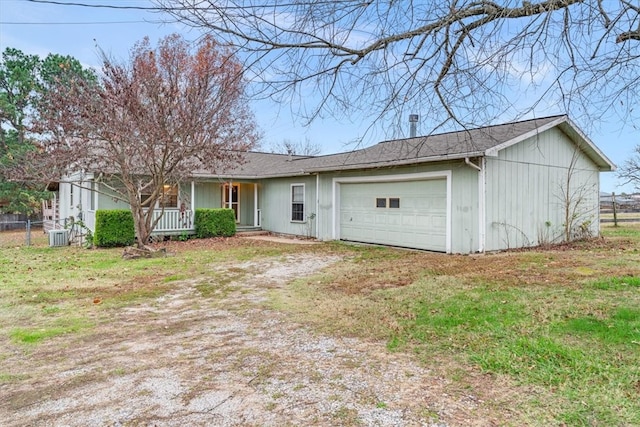 single story home with a front yard, a porch, and a garage