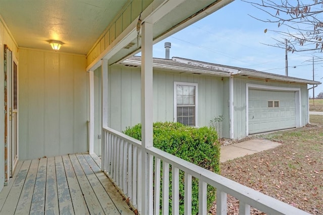 exterior space with a porch and a garage