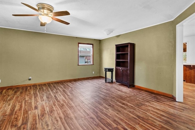 unfurnished room featuring wood-type flooring, ceiling fan, and ornamental molding