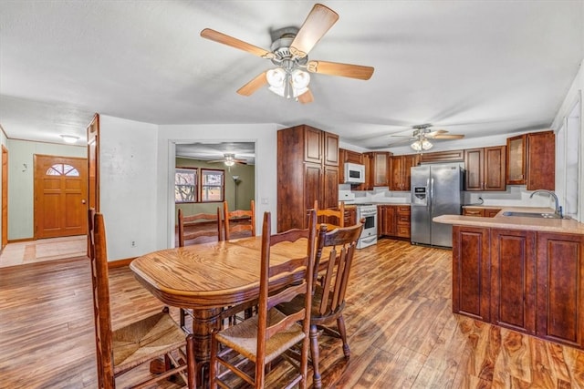 dining space featuring wood-type flooring and sink