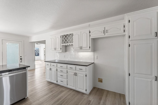 kitchen with white cabinetry, light hardwood / wood-style flooring, and stainless steel dishwasher