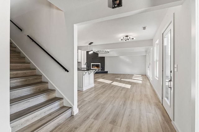 entryway featuring sink and light wood-type flooring