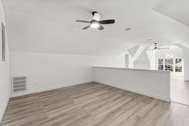 bonus room featuring ceiling fan, light hardwood / wood-style floors, and lofted ceiling