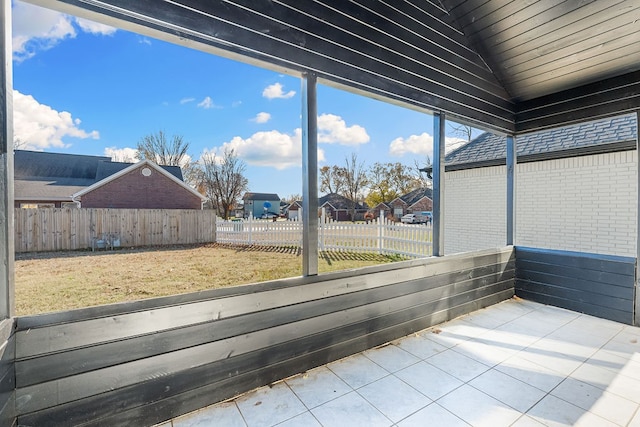 unfurnished sunroom featuring a healthy amount of sunlight, lofted ceiling, and wooden ceiling