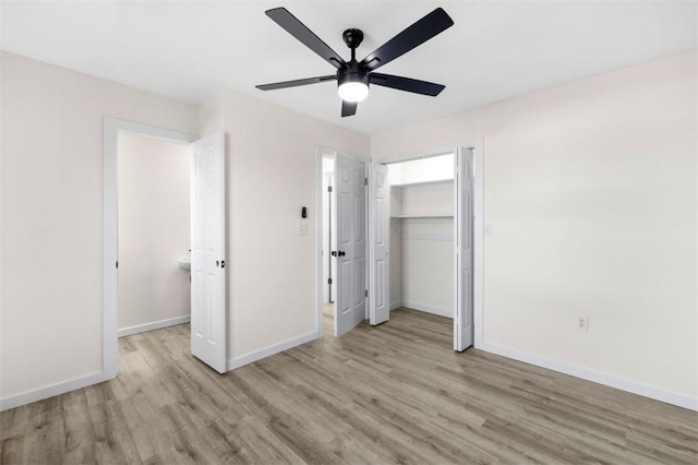 unfurnished bedroom featuring light hardwood / wood-style flooring, a closet, and ceiling fan