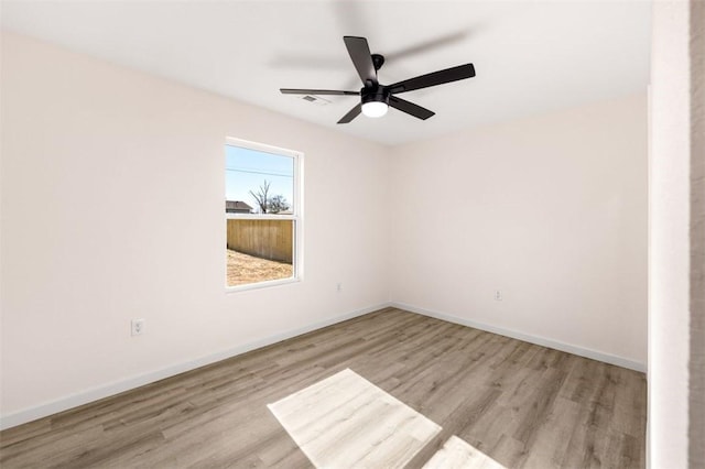 empty room featuring ceiling fan and light hardwood / wood-style flooring