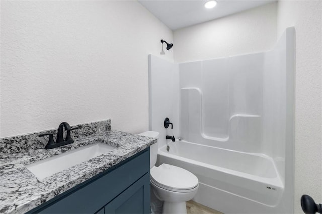 full bathroom featuring vanity, bathing tub / shower combination, and toilet