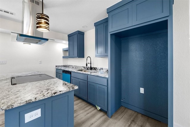 kitchen with blue cabinetry, sink, light stone counters, light hardwood / wood-style flooring, and stainless steel dishwasher