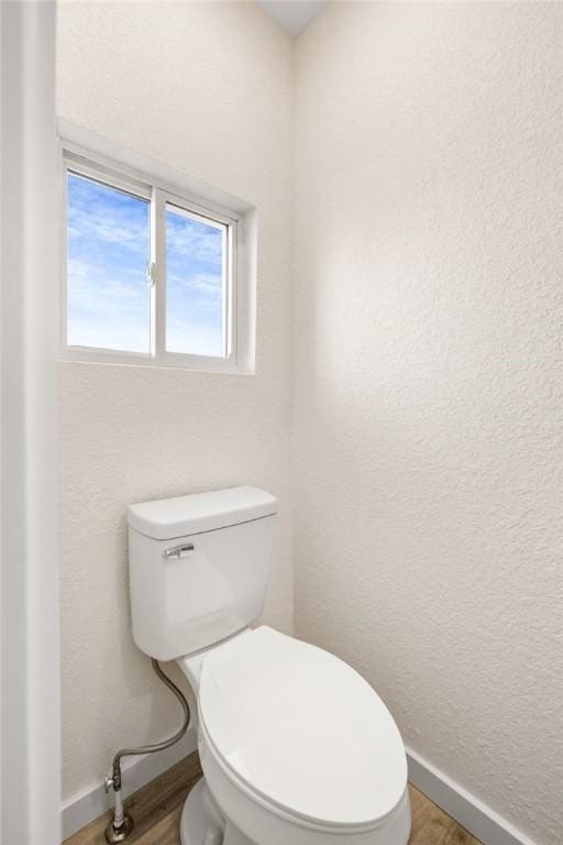 bathroom featuring wood-type flooring and toilet