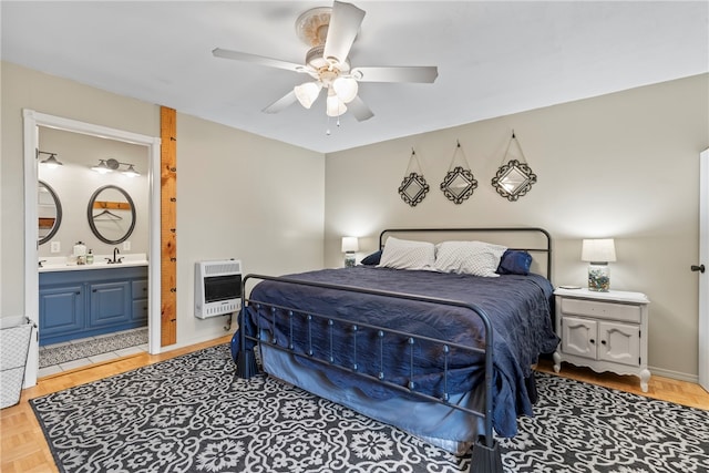 bedroom featuring heating unit, sink, ensuite bath, ceiling fan, and light parquet flooring