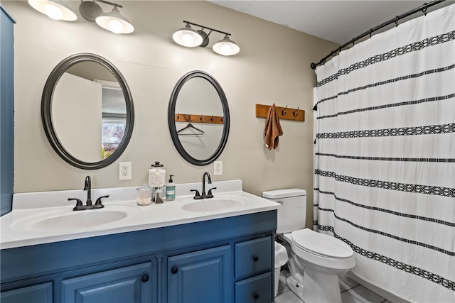 bathroom featuring a shower with shower curtain, tile patterned floors, vanity, and toilet