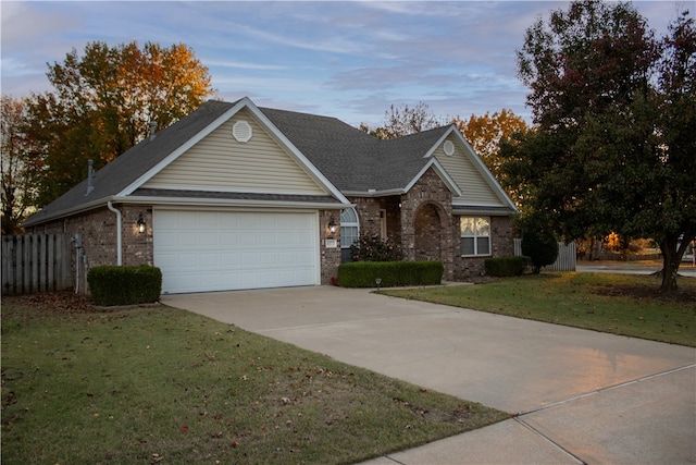 view of front facade with a garage and a lawn