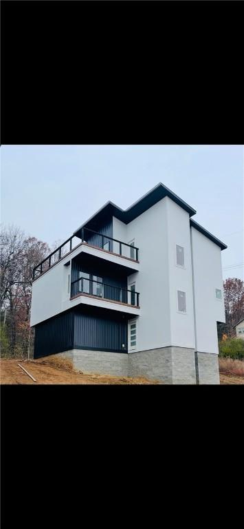 back of house with a balcony