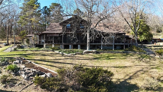 back of house featuring a sunroom and a yard