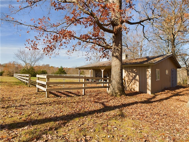 view of yard with an outbuilding and a rural view