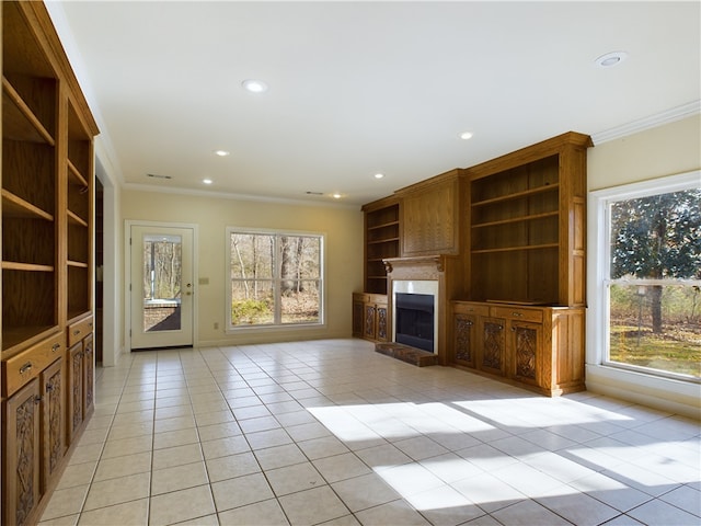 unfurnished living room with crown molding and light tile patterned floors