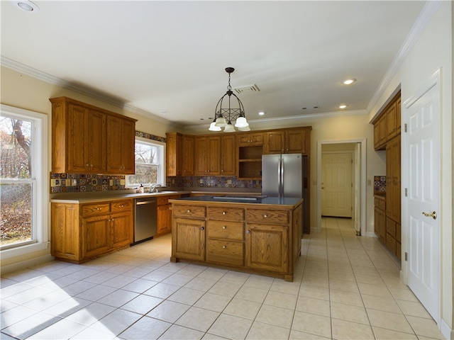 kitchen with decorative backsplash, decorative light fixtures, stainless steel appliances, and a kitchen island