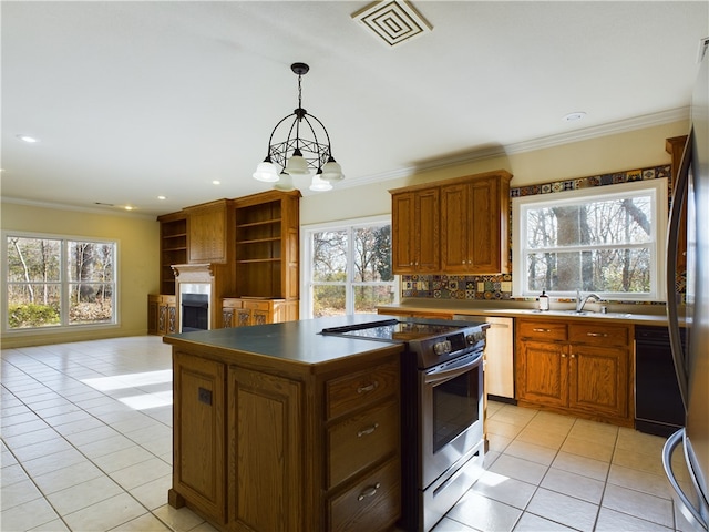 kitchen with stainless steel appliances, a kitchen island, an inviting chandelier, decorative light fixtures, and light tile patterned flooring