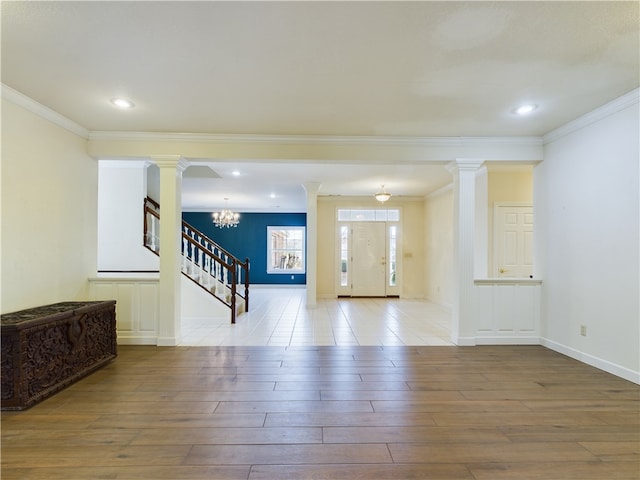 interior space featuring a notable chandelier, wood-type flooring, and crown molding